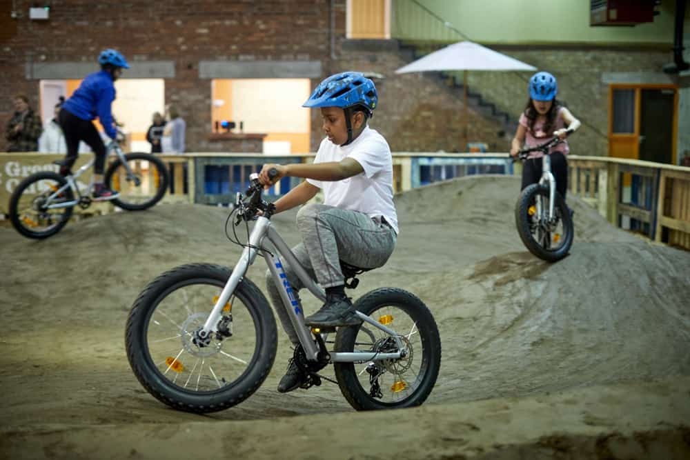 Children ride the indoor pumptrack