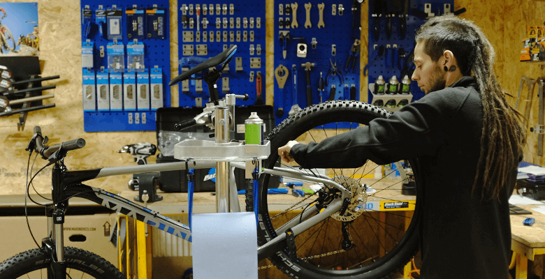 Kyle works on a bike in the workshop