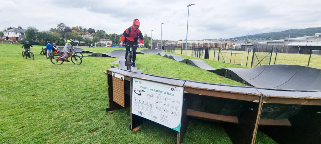 Young person using the Dirt Factory pump track